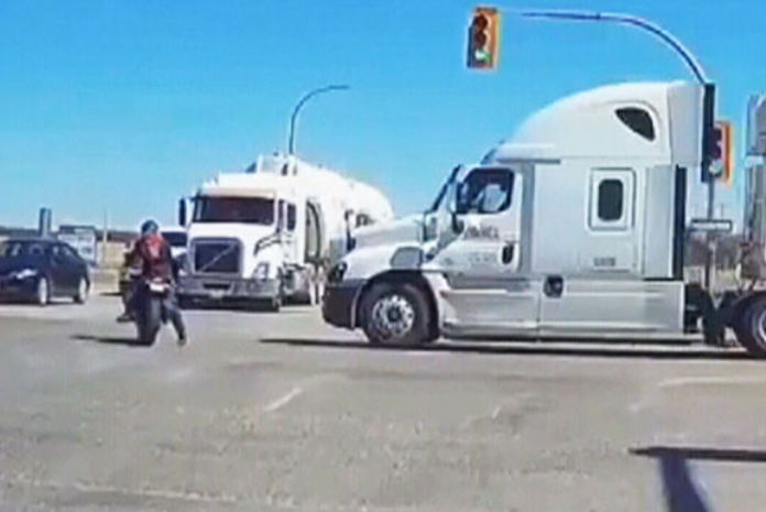 VIDEO: Police say that trucker was distracted when he hit motorcyclist