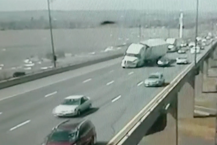 VIDEO: Wind nearly topples truck on top of car