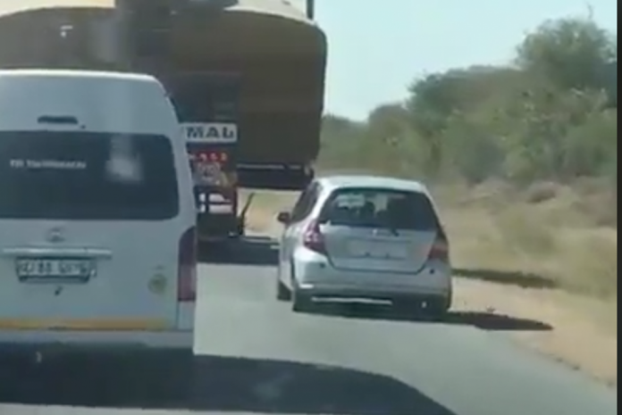 VIDEO: Dumb driver pays the price for trying to pass oversized load on the shoulder