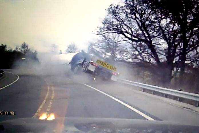 VIDEO: Semi truck with oversize load topples on a fast turn