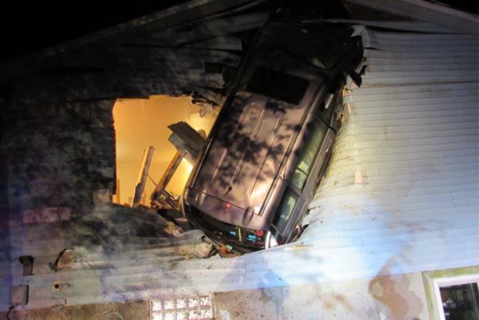 Suspected intoxicated driver launches minivan into the air and wedges it into a house
