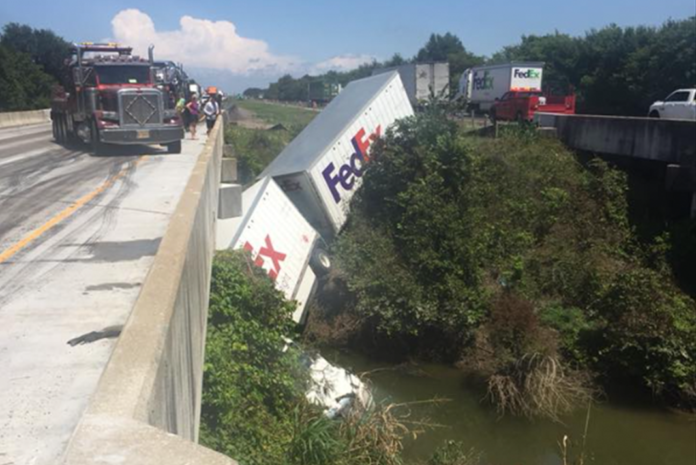 Truck driver hurt after crashing off I-40 into creek