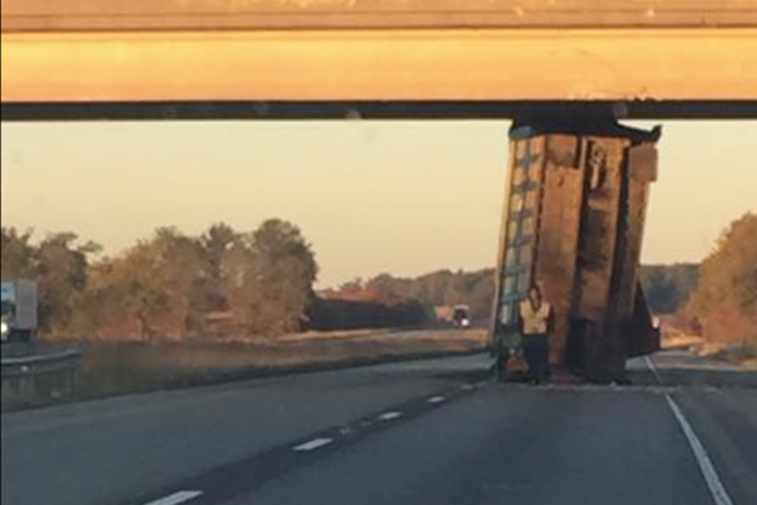 Dump truck gets wedged under Illinois overpass