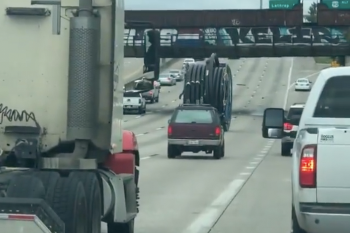 Watch a giant industrial spool roll through Houston traffic