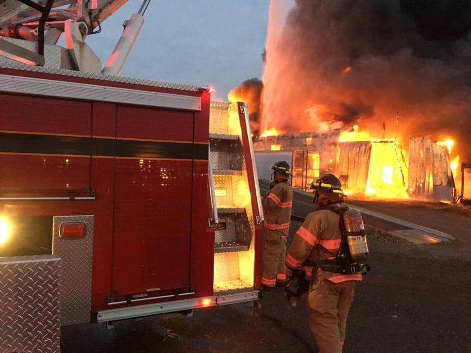 Authorities look for clues after massive fire destroys trucking company facility