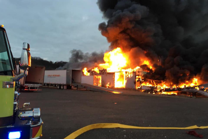 Authorities look for clues after massive fire destroys trucking company facility