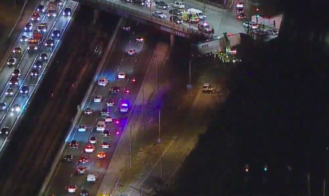 Failed turn onto exit ramp leaves big rig dangling from overpass