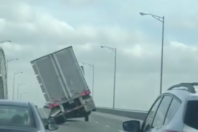 Watch a big rig battle high winds on notorious bridge -- and win