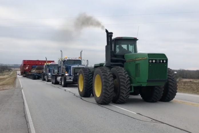 Watch as a 2 million pound load get a little help from a Deere
