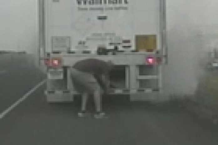 Watch as tires explode while trucker is under big rig battling a blaze