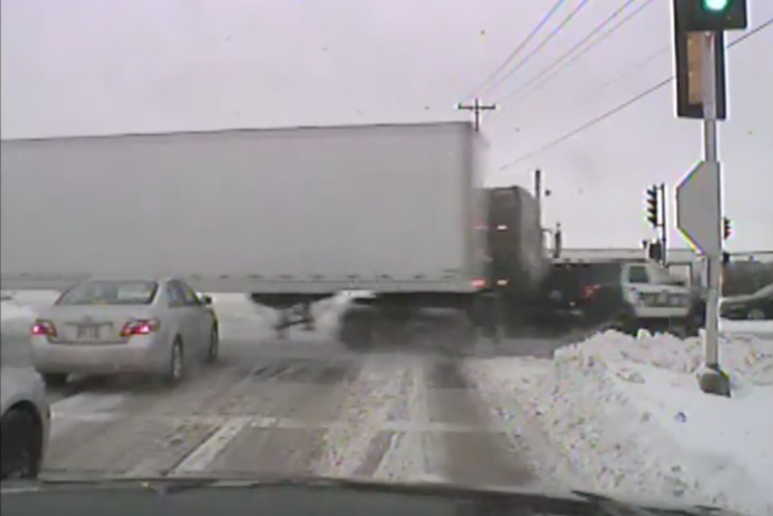 Trucker blamed for T-boning cop while skidding in icy intersection