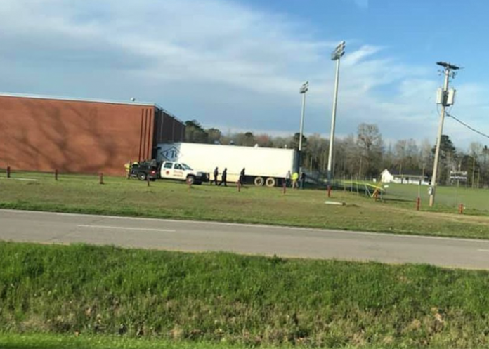 Semi truck slams into high school, killing truck driver