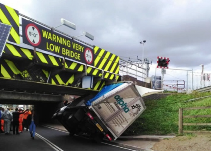Truck gets stuck under 'very low bridge' just days after new signs go up