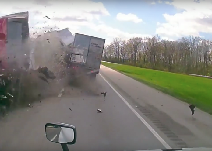 Head-on two truck crash skins open side of semi trailer