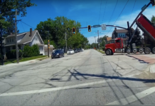 Dump truck tangles with traffic light