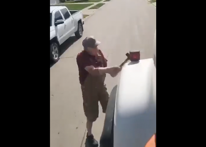 Irate neighbor bashes concrete truck with hammer in baffling video