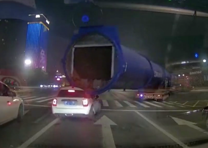 Truck driver adds car to already oversized haul