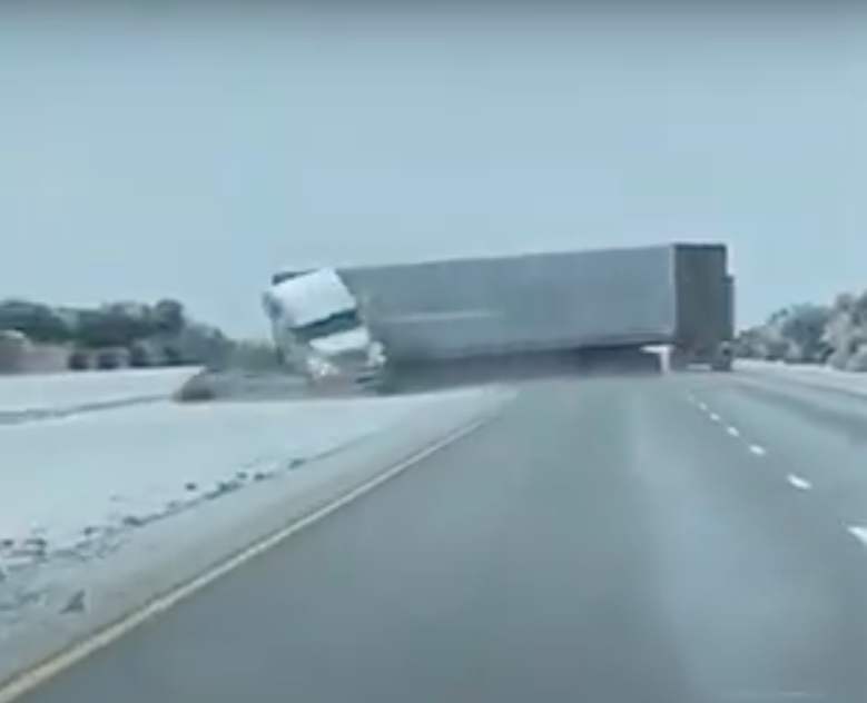 Watch a trucker lose control and jackknife on an icy Texas roadway