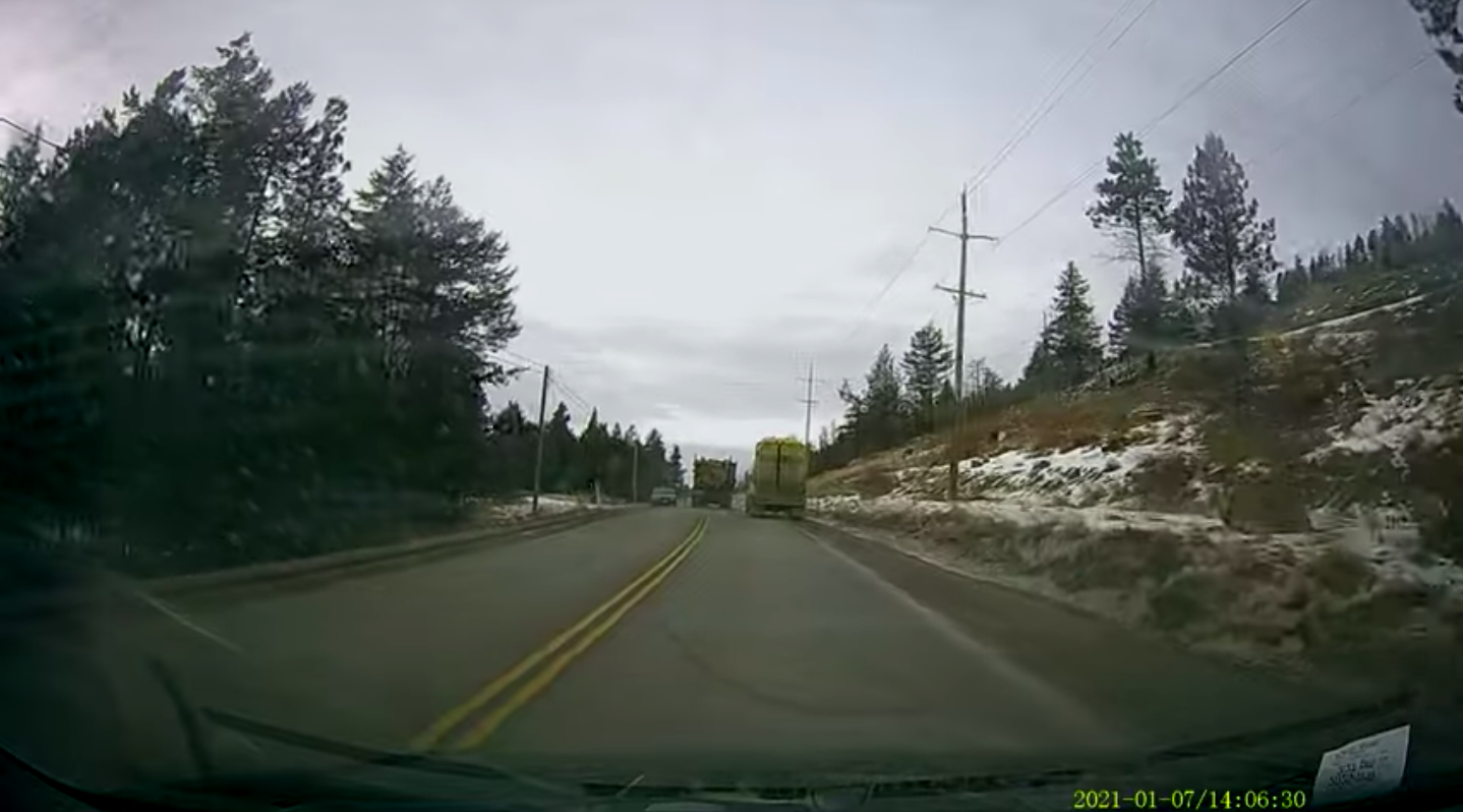 VIDEO: Log truck driver’s double yellow pass causes scary close call