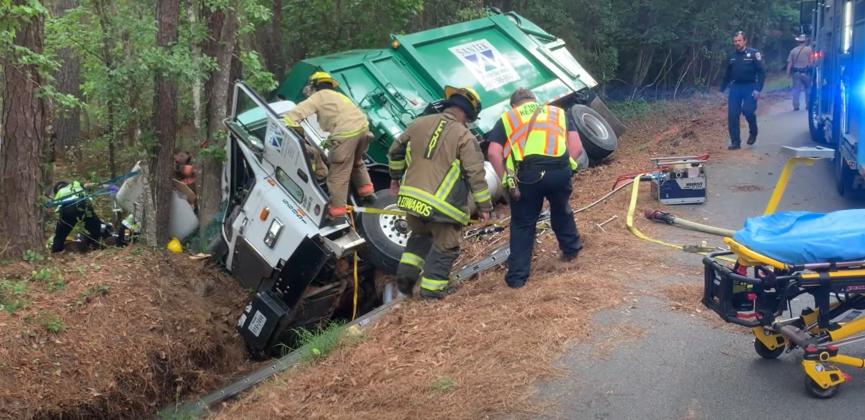 Pinned garbage truck driver freed after two-hour-long rescue