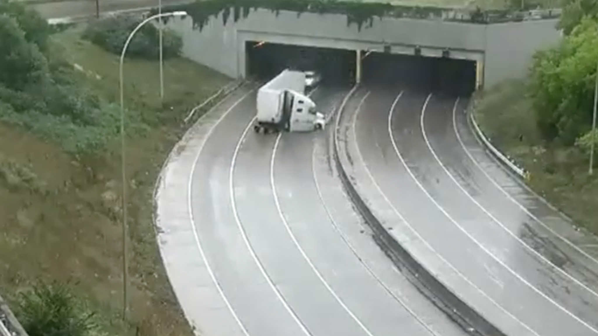 Traffic cams capture semi truck jackknife in rainslick Minneapolis tunnel