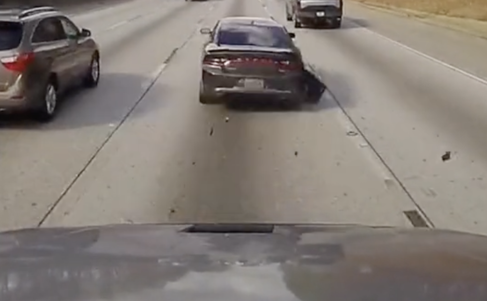 VIDEO: Weaving, speeding four-wheeler clips semi at high speed