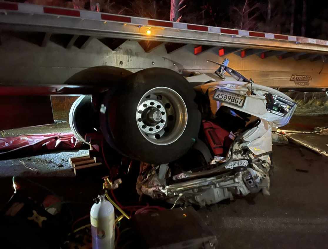 Car ends up beneath flatbed in two vehicle wreck