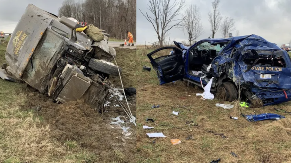 Trooper trapped after semi plows into stopped patrol car 