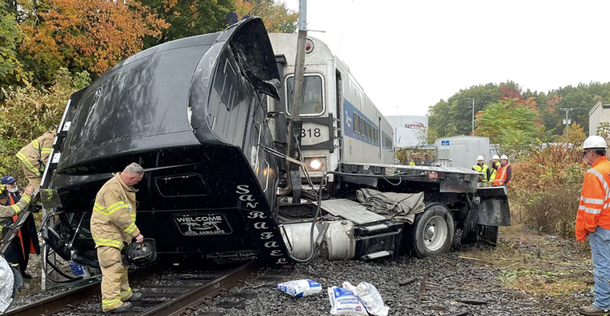 Semi truck struck by passenger train while fleeing scene of previous wreck