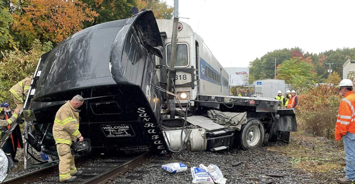 Semi truck struck by passenger train while fleeing scene of previous wreck 