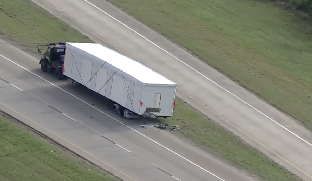 Texas sheriff says one dead in crash that left car wedged under parked oversized load