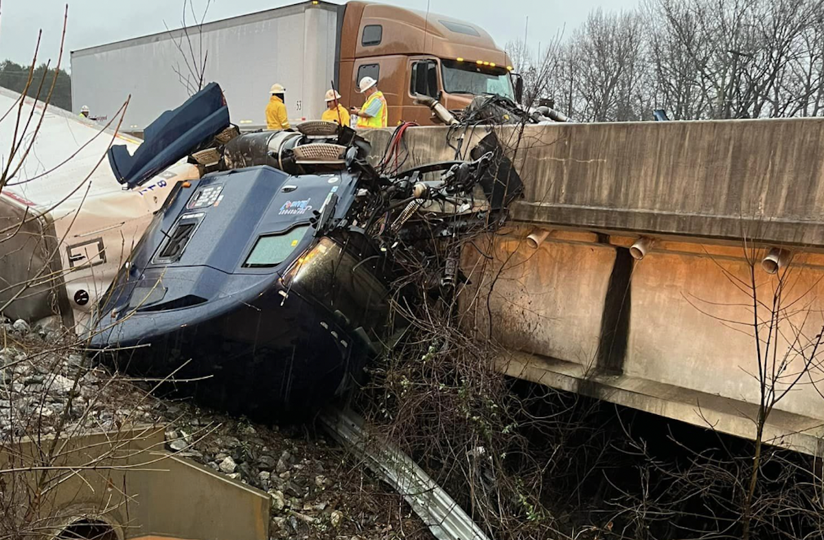 No injuries reported after semi truck crashes over concrete barrier