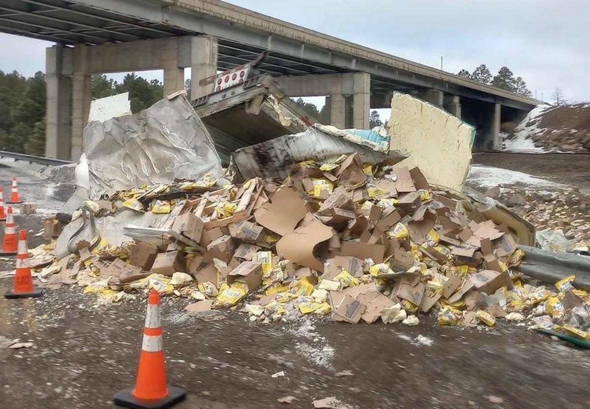 Trucker found walking around after trailer topples off road, cab left overturned on overpass