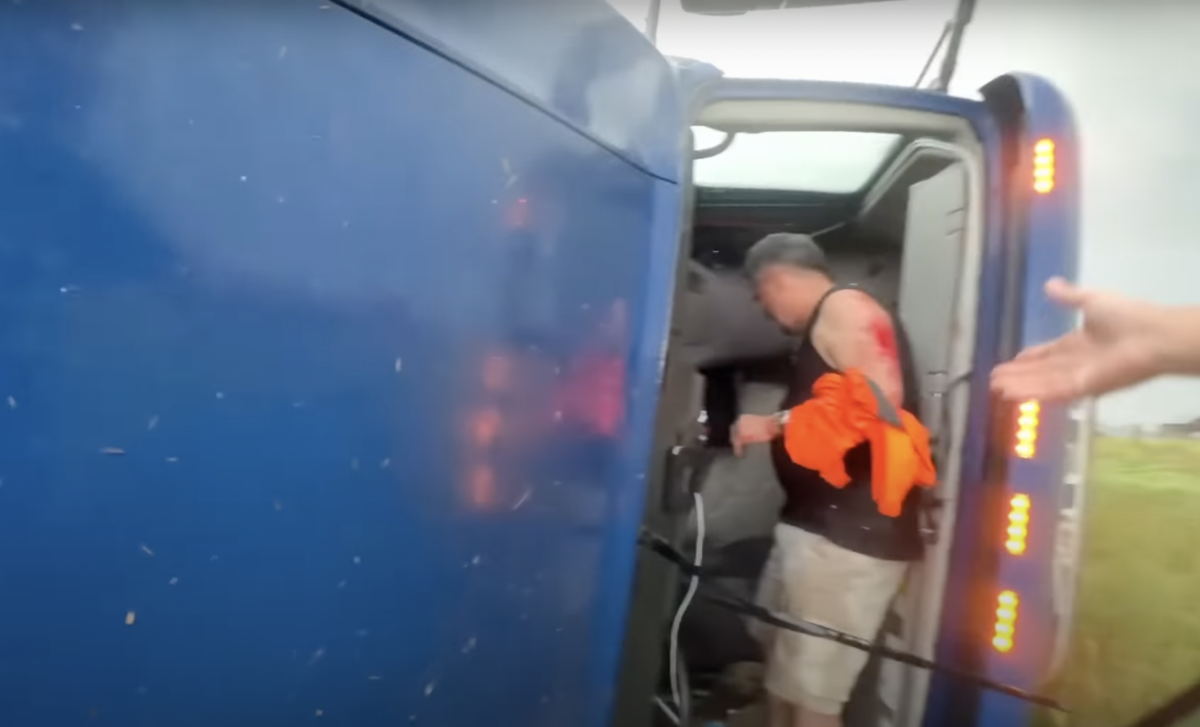 VIDEO: Storm chaser stops to help trucker tipped over by Wyoming tornado