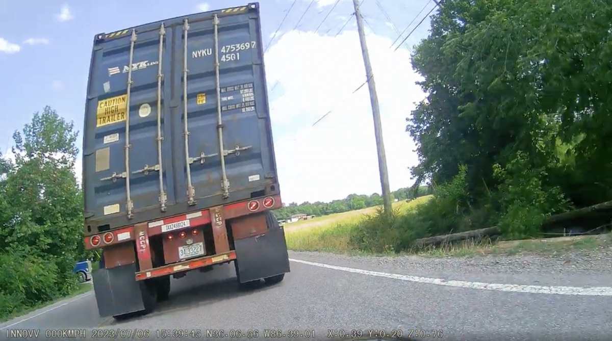 VIDEO: Motorcyclist jumps to safety before backing big rig runs over his bike