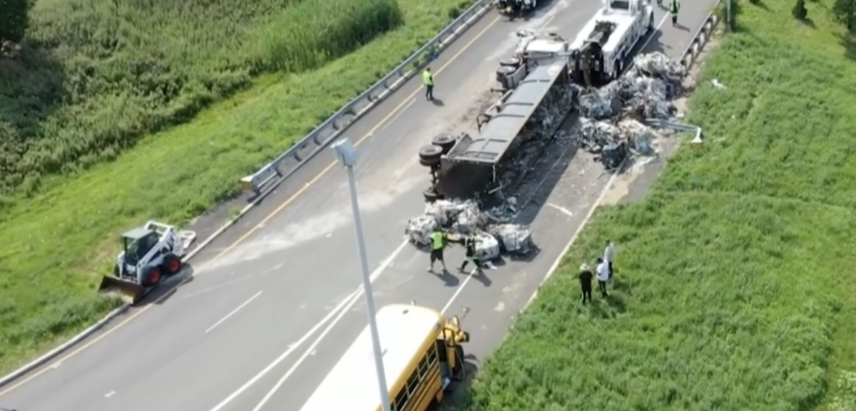 Flipped tractor trailer strikes school bus 