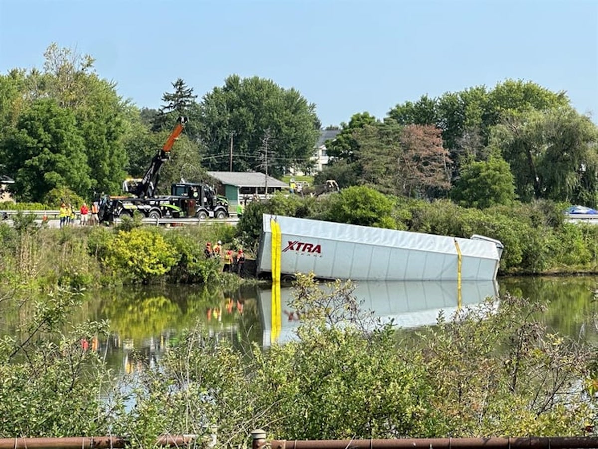 Trucker rescued when passing officer noticed trailer sticking out of pond 