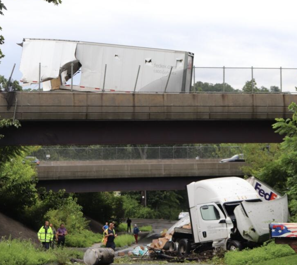 Rear trailer left on bridge as rest of rig plummets off roadway