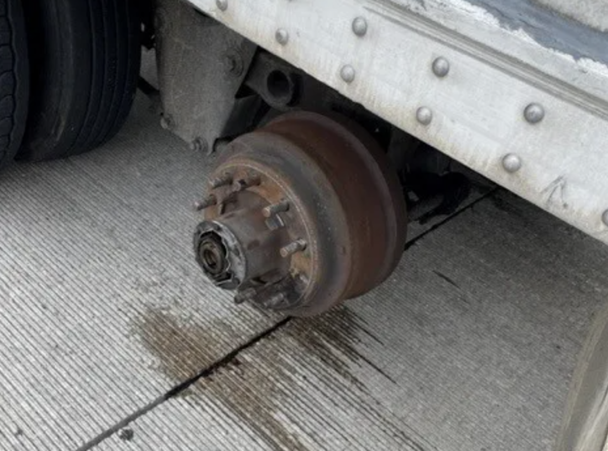 Teen struck by loose semi truck wheel while changing tire