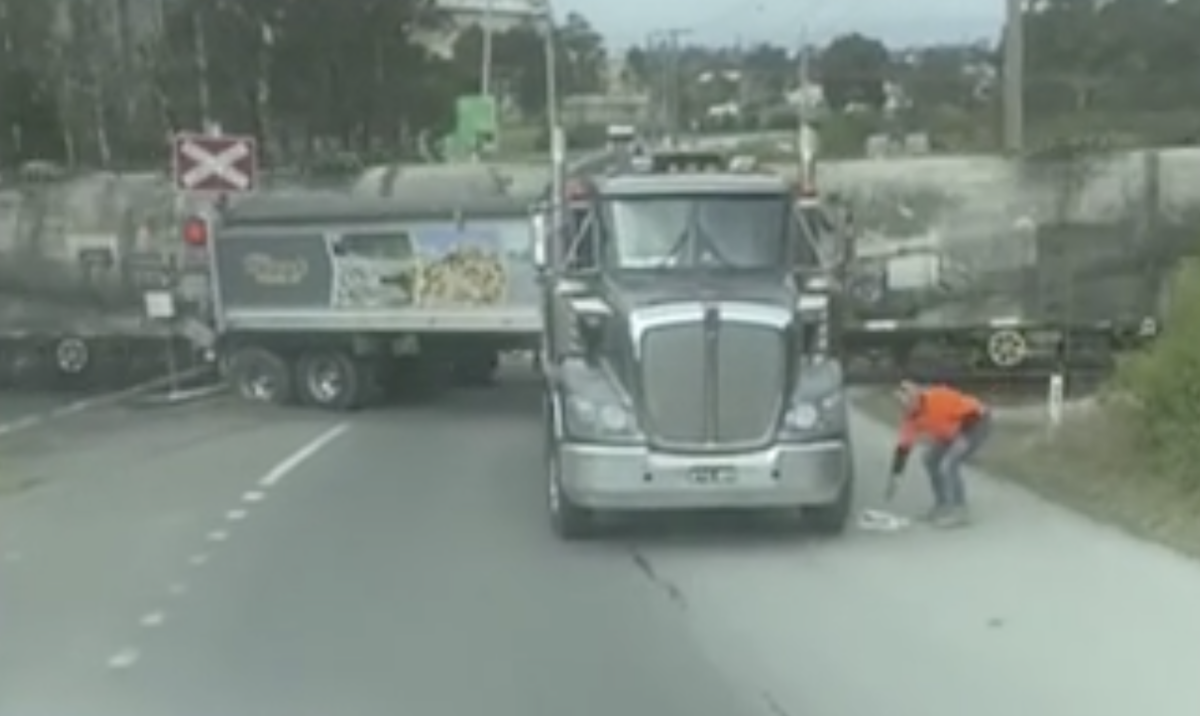 Watch a trucker jauntily trot away from his rig as a train smacks into it 