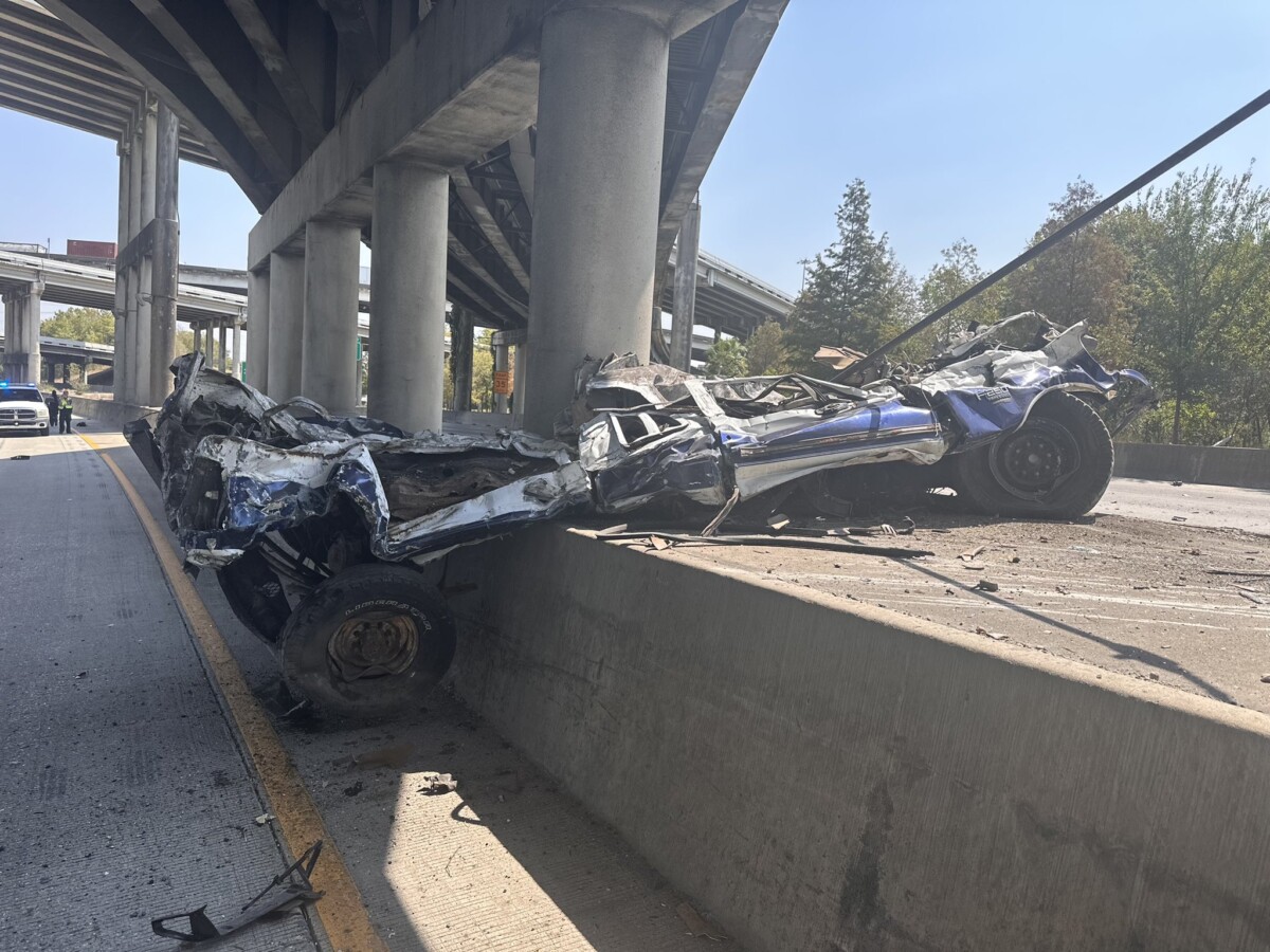 Crushed cars fall off overpass after semi truck flips