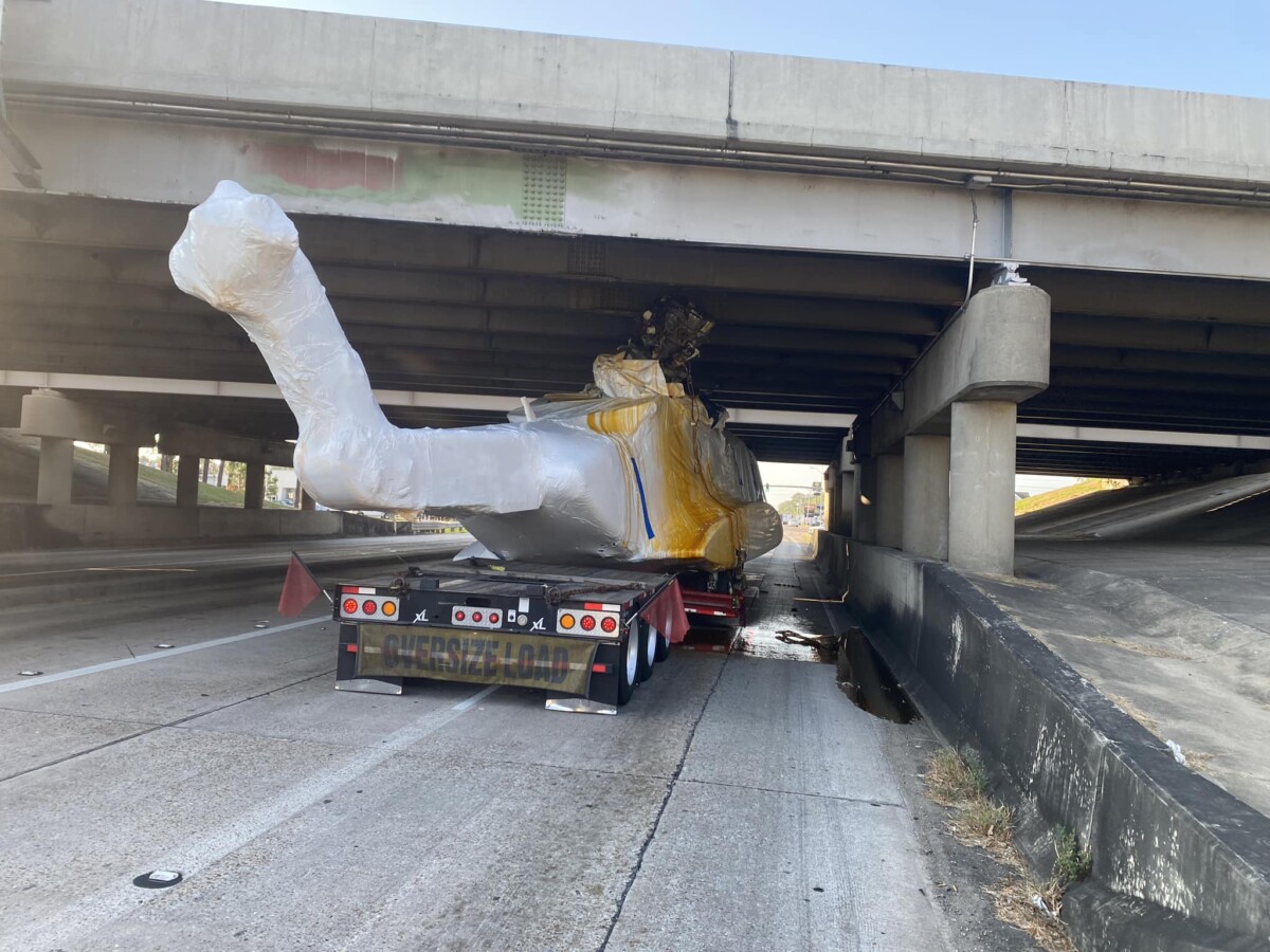 Truck hauling helicopter gets snagged on overpass in Louisiana