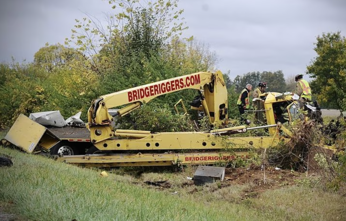 Driver trapped after wrecking rig outfitted as a mobile crane