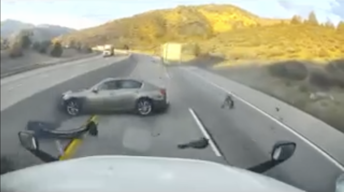 VIDEO: Trucker hauling doubles barely keeps it upright after taking a hit from a car