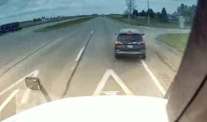 Dash cam shows car pull in front of semi-truck