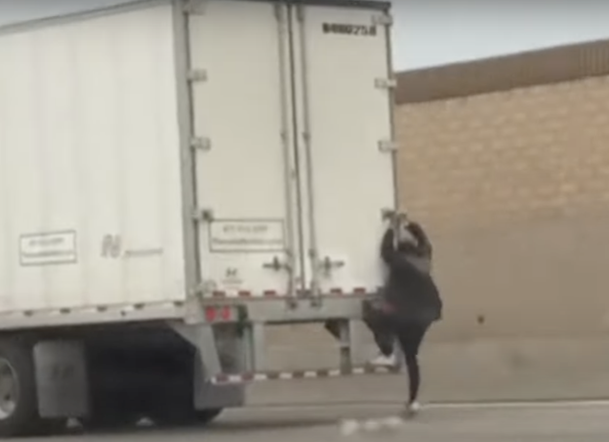 Man filmed hitching a ride on a semi truck before bailing off in concerning  fashion