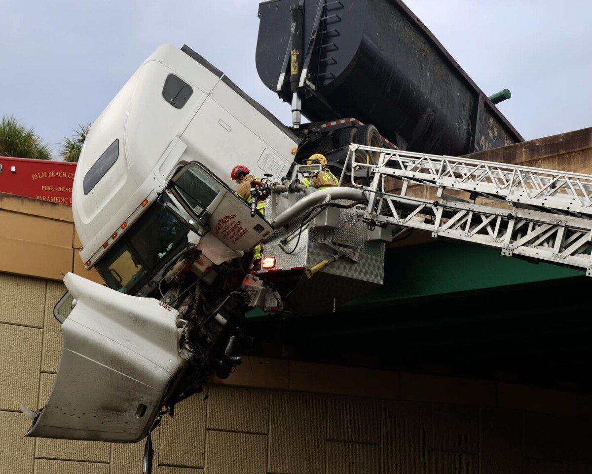 Video shows Florida firefighters rescuing a trucker from a big rig dangling from overpass