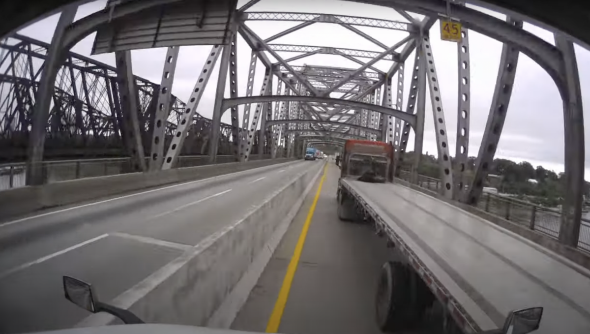 VIDEO: Flatbed truck rear-ended by semi after it stopped suddenly on a bridge