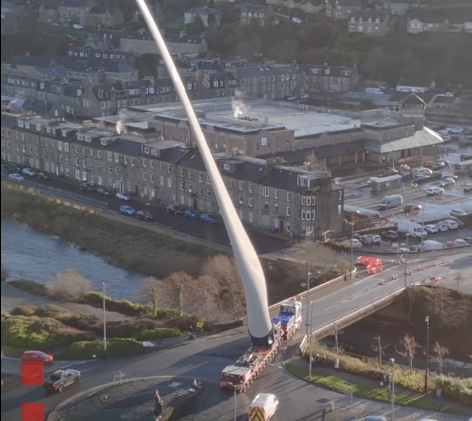 Watch how heavy haulers maneuver giant wind turbine blades through a tiny town