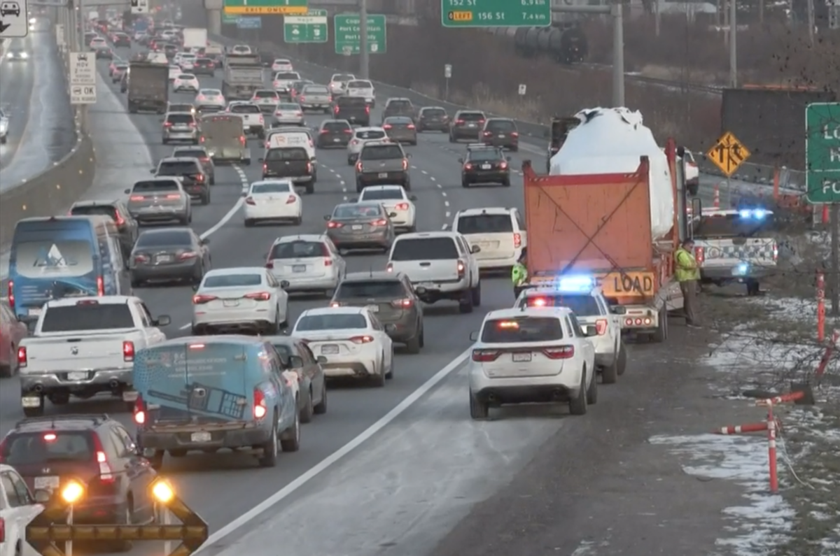 Trucking company ordered off the road after oversized helicopter load hits highway sign